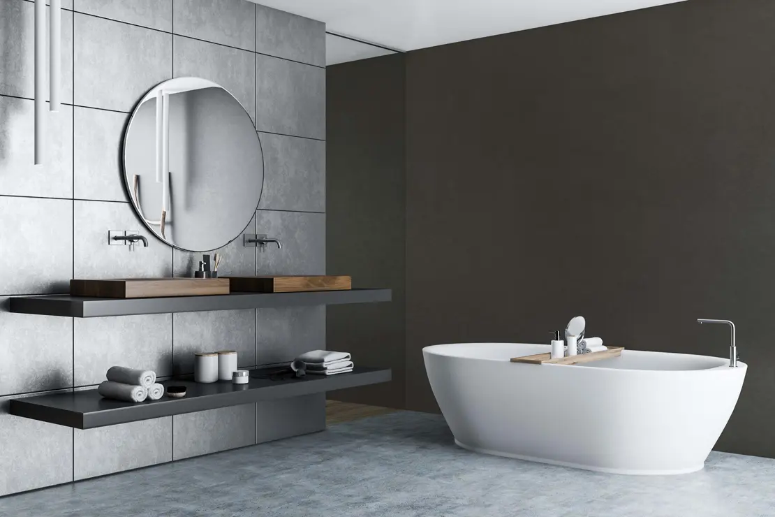 Baño con muros de microcemento de tono gris profundo